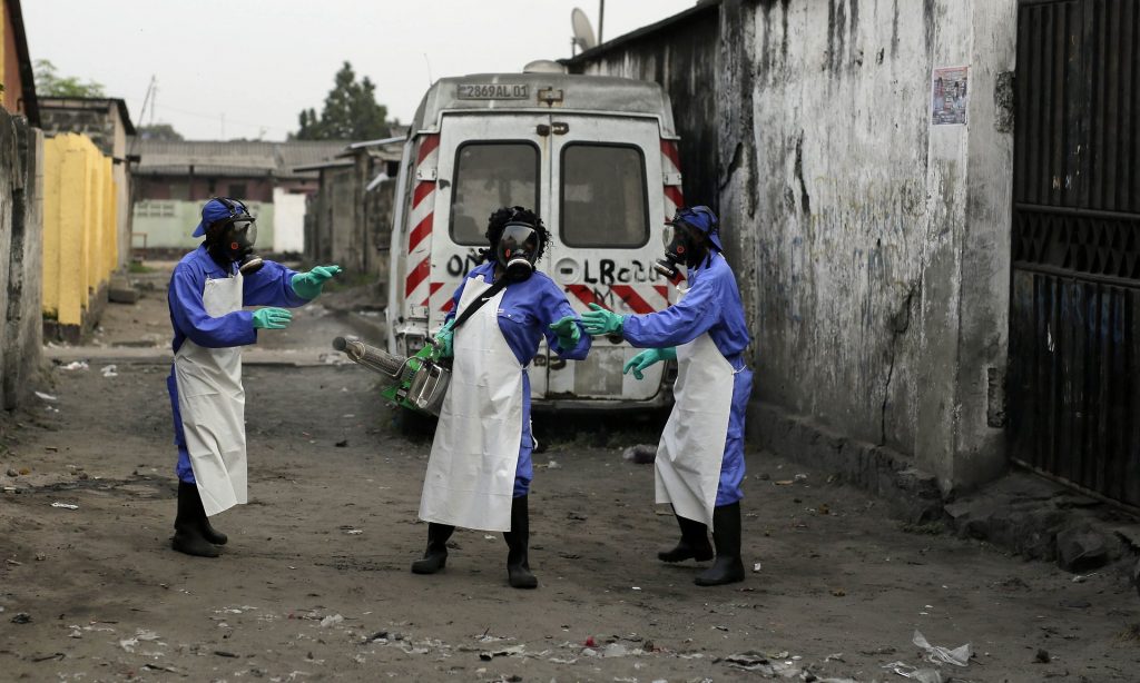 Members of a Médecins Sans Frontières team fumigate the Yolo Sud neighbourhood of Kinshasa. Photograph: Jerome Delay/AP
