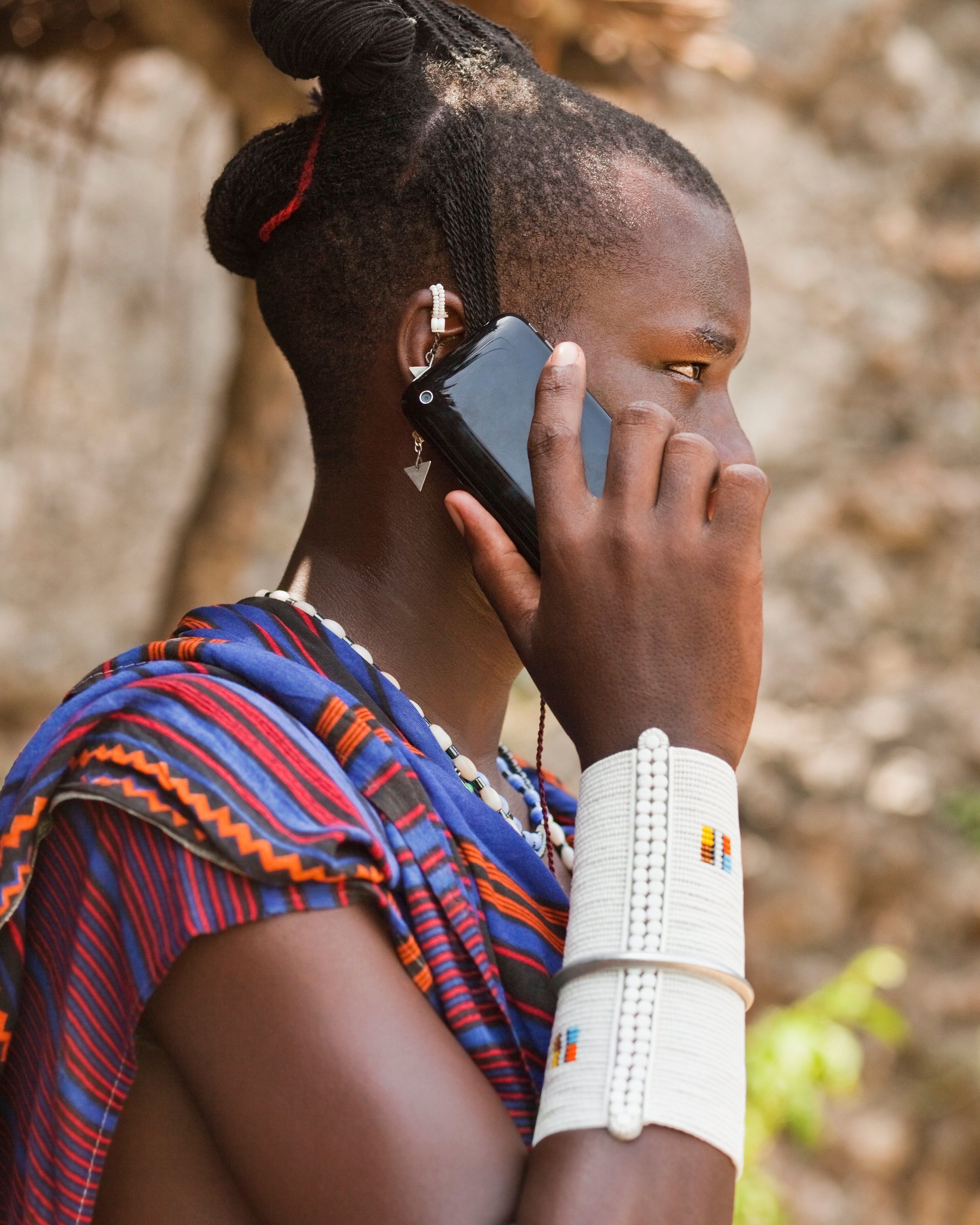 A Maasai man in traditional dress using a smartphone. Photograph: Age fotostock/Alamy