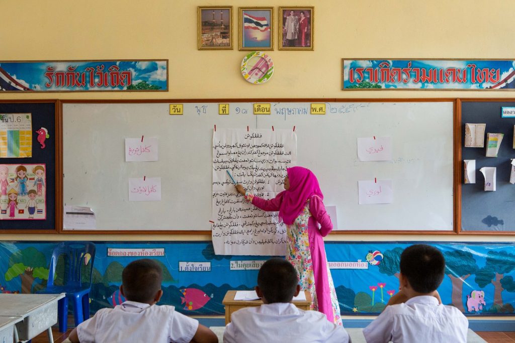 At Banbuengnamsai primary school, which signed up to a pilot programme to integrate Patani-Malay languages in schools, a teacher gives an Arabic lesson. Photographs: Irin