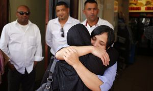 Celeste Nurse, right, the biological mother of the kidnapped child, embraces a family member. Photograph: Schalk van Zuydam/AP