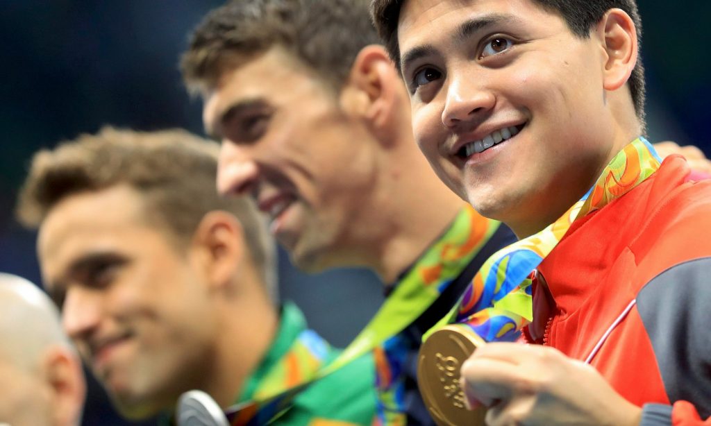 Joseph Schooling poses with his gold medal after winning the men’s 100m butterfly final. Photograph: Dominic Ebenbichler/Reuters