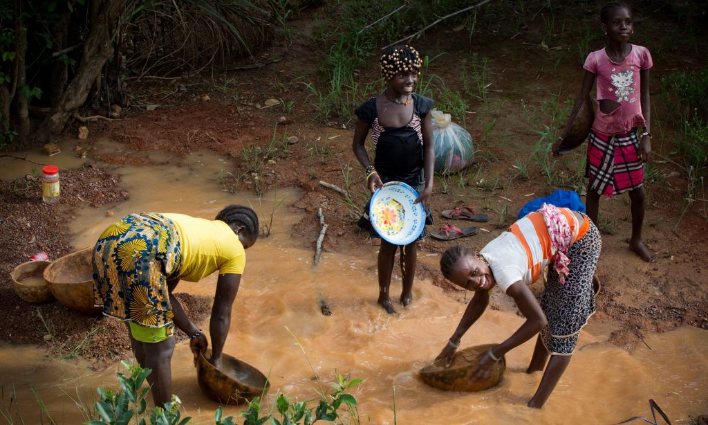 Women pan for gold in the mining area of Siguiri, Guinea. It was in such circumstances that Lounceny contracted polio. Photograph: Kate Holt/Unicef