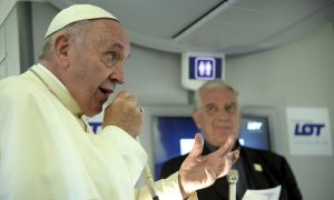 Pope Francis speaks to journalists on board the flight from Kraków to Rome at the end of his trip to southern Poland. Photograph: Filippo Monteforte/AP