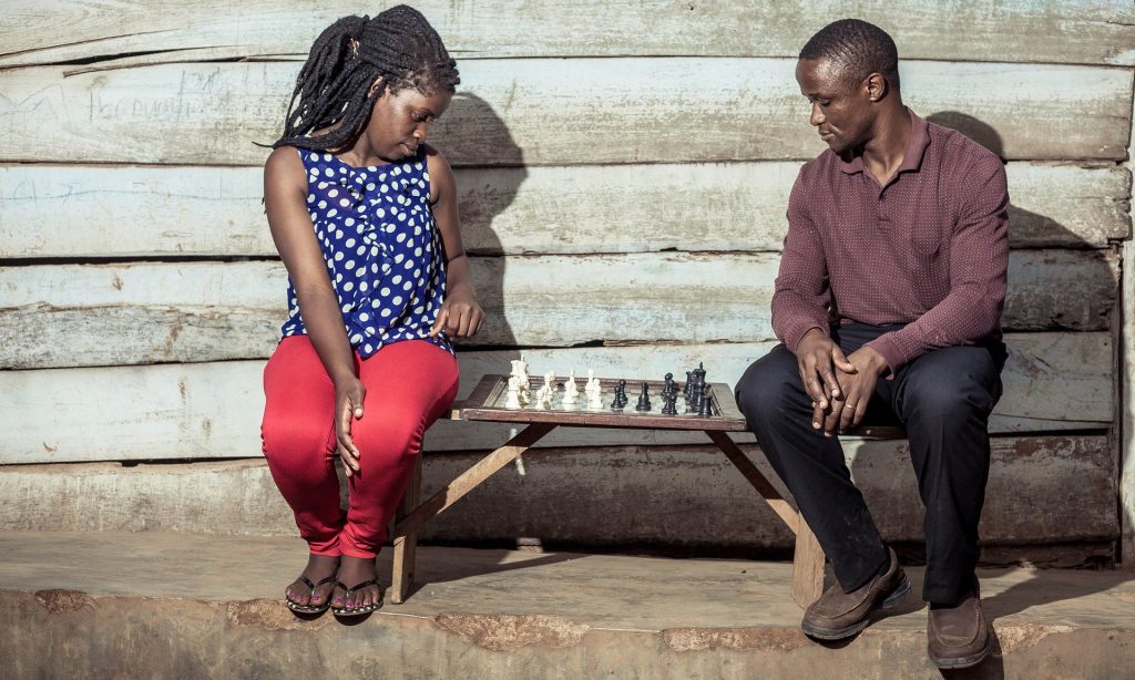 All the right moves: Phiona Mutesi with her chess mentor Robert Katende . Photograph: Muyingo Siraj