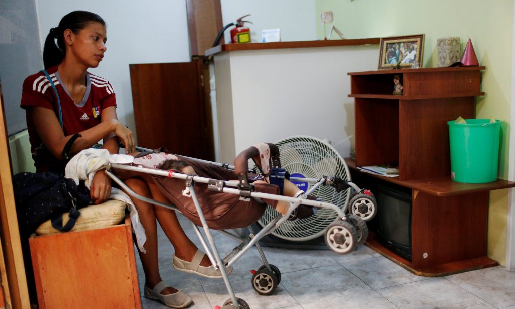 Geraldine Rocca, 29, waits for the results of a pregnancy test before her sterilization surgery in Caracas, Venezuela. Photograph: Carlos Garcia Rawlins/Reuters