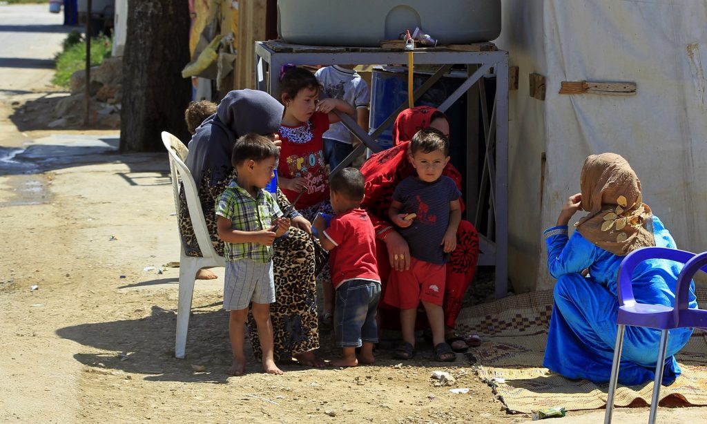 Syrian mothers and children at a refugee camp in the eastern Lebanese town of Saadnayel. Photograph: Bilal Hussein/AP