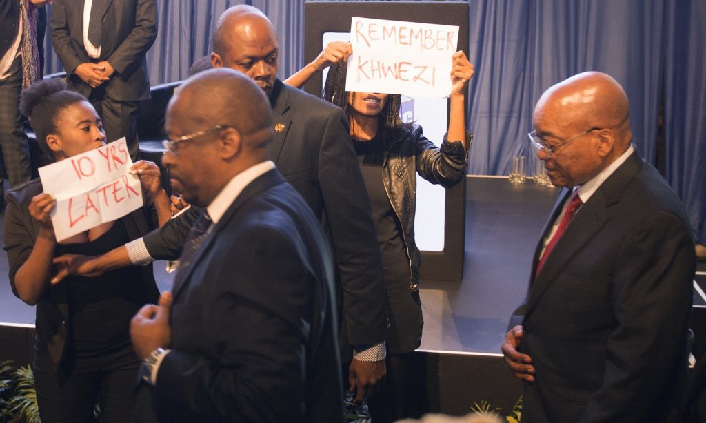 Security guards escort Zuma paast the protesters. Photograph: Herman Verwey/AP