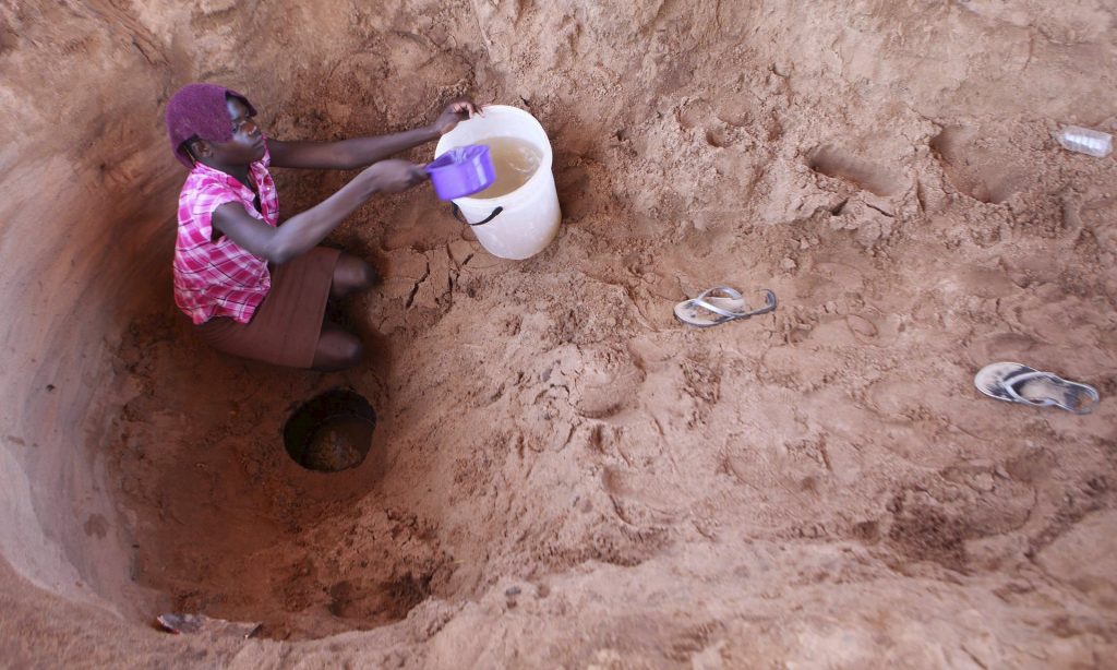 A woman fetches drinking water from a well near Gokwe, Zimbabwe, 20 May 2015. Photograph: Philimon Bulawayo/Reuters