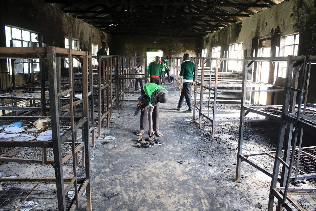 Students of St Peter’s Nyamesocho school in Kisii county rummage through a burnt-out dormitory for salvageable items following an arson attack. Photograph: AFP/Getty Images