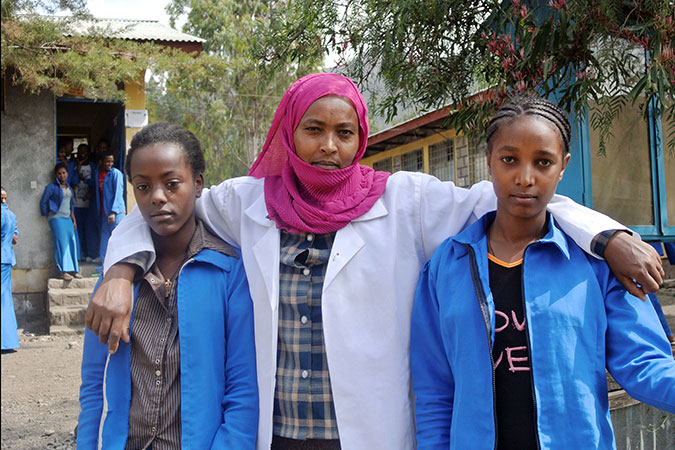 In 2013 the programme supported school gender-clubs, where students regularly come together to discuss how to prevent violence against women in school communities. School gender-club members Eden and Abeba with the teacher and leader Lubaba at Woldia General Secondary School in the Amhara region of northern Ethiopia. Photo: UN Women/Kristin Ivarsson