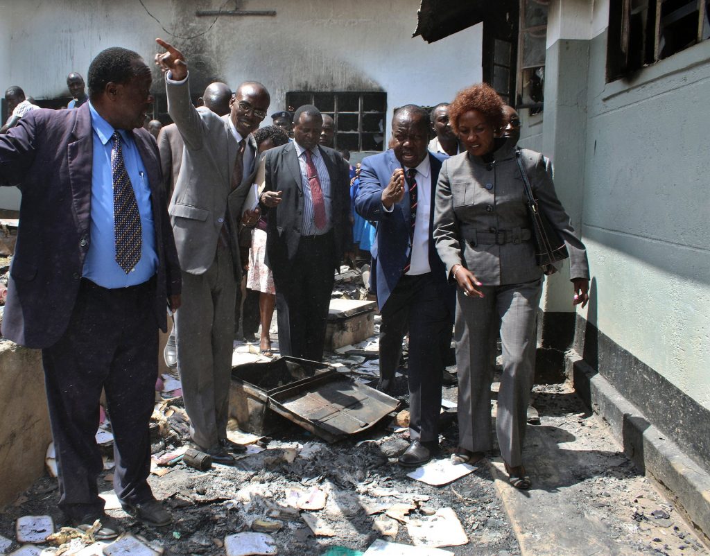 Kenyan education secretary Fred Matiangi inspects a building destroyed by fire at Itierio boys’ high school in Kisii county. Photograph: AFP/Getty Images