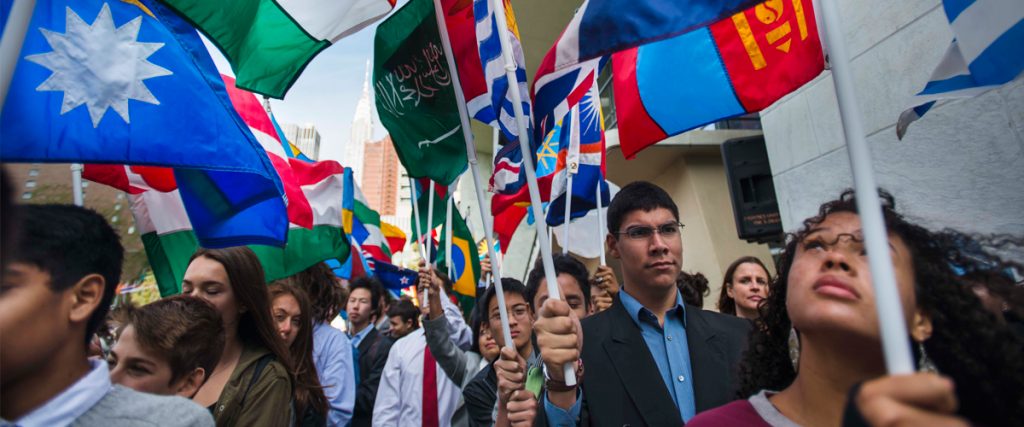 Students carrying Members States' flags during annual Peace Bell Ceremony, United Nations, New York