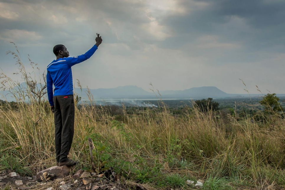 A young South Sudanese refugee tries to get a signal on his mobile phone in Nyumanzi refugee settlement, Adjumani, northern Uganda, in this 2014 file photo. © UNHCR/ Frederic Noy