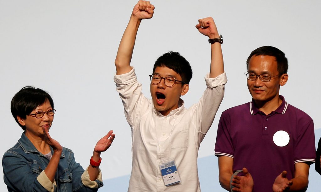 Student leader Nathan Law celebrates on the podium after his win in the Legislative Council election in Hong Kong. Photograph: Bobby Yip/Reuters