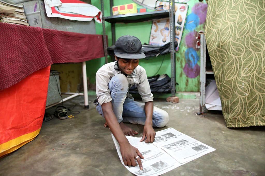 Mohammed Javed,15, is a rag picker. He spends most of his time in and around railway stations and sleeps unders a bridge. he is also a news-gatherer working on the newspaper and proudly shows off one of his stories. (Showkat Shafi/Al Jazeera)