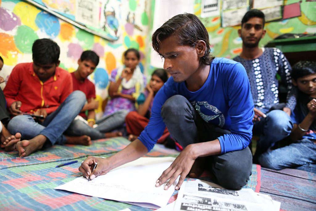 Chetan, 17, works as a domestic helper and  is a reporter. 'This paper has given us wings, no one used to listen to us poor kids, but now we publish all the atrocities we face in our daily life,' he says. (Showkat Shafi/Al Jazeera)