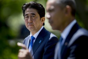 Shinzo Abe, Japan's prime minister, left, looks on as U.S. President Barack Obama speaks during a joint news conference in the Rose Garden of the White House in Washington, D.C., U.S., on Tuesday, April 28, 2015. Prime Minister Shinzo Abe goes before the U.S. Congress on Wednesday to present Japan as a stalwart ally that's willing to play a bigger military role in Asia, a message likely to be embraced in Washington and greeted with suspicion in Seoul and Beijing. Photographer: Andrew Harrer/Bloomberg *** Local Caption *** Shinzo Abe; Barack Obama