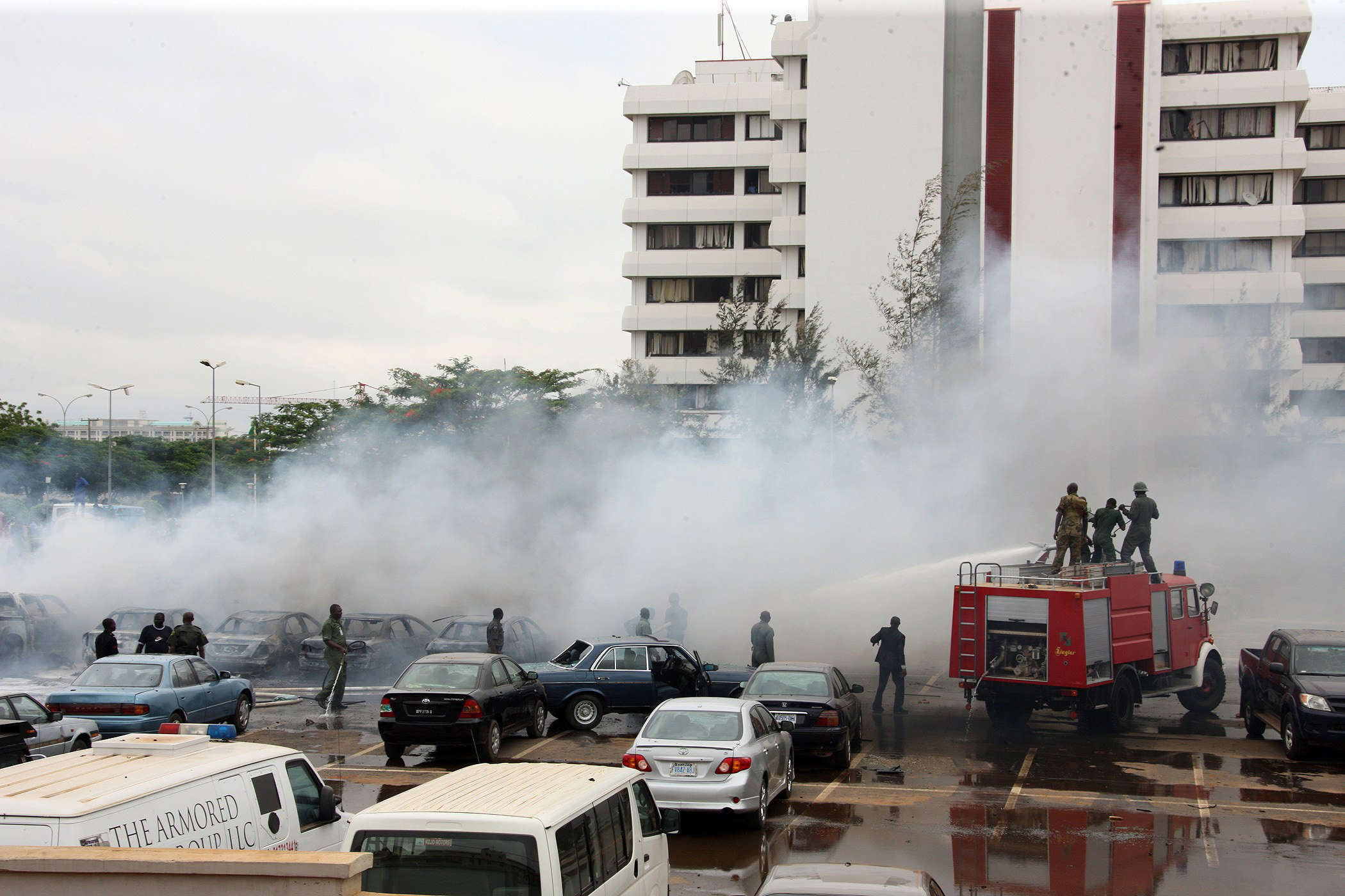 Firefighters try to extinguish a fire after a bomb blast at the parking lot of police headquaters in Abuja on June 16, 2011. The bomb killed two people and damaged several vehicles. Nigerian police suspect the radical Islamic sect Boko to be behind the "suicide" bombing. The Islamist Boko Haram sect on June 15, 2011 threatened "fiercer" attacks and said it would not enter into talks with the government, which it had earlier proposed. AFP PHOTO/ SUNDAY AGHAEZE (Photo credit should read Sunday Aghaeze/AFP/Getty Images)