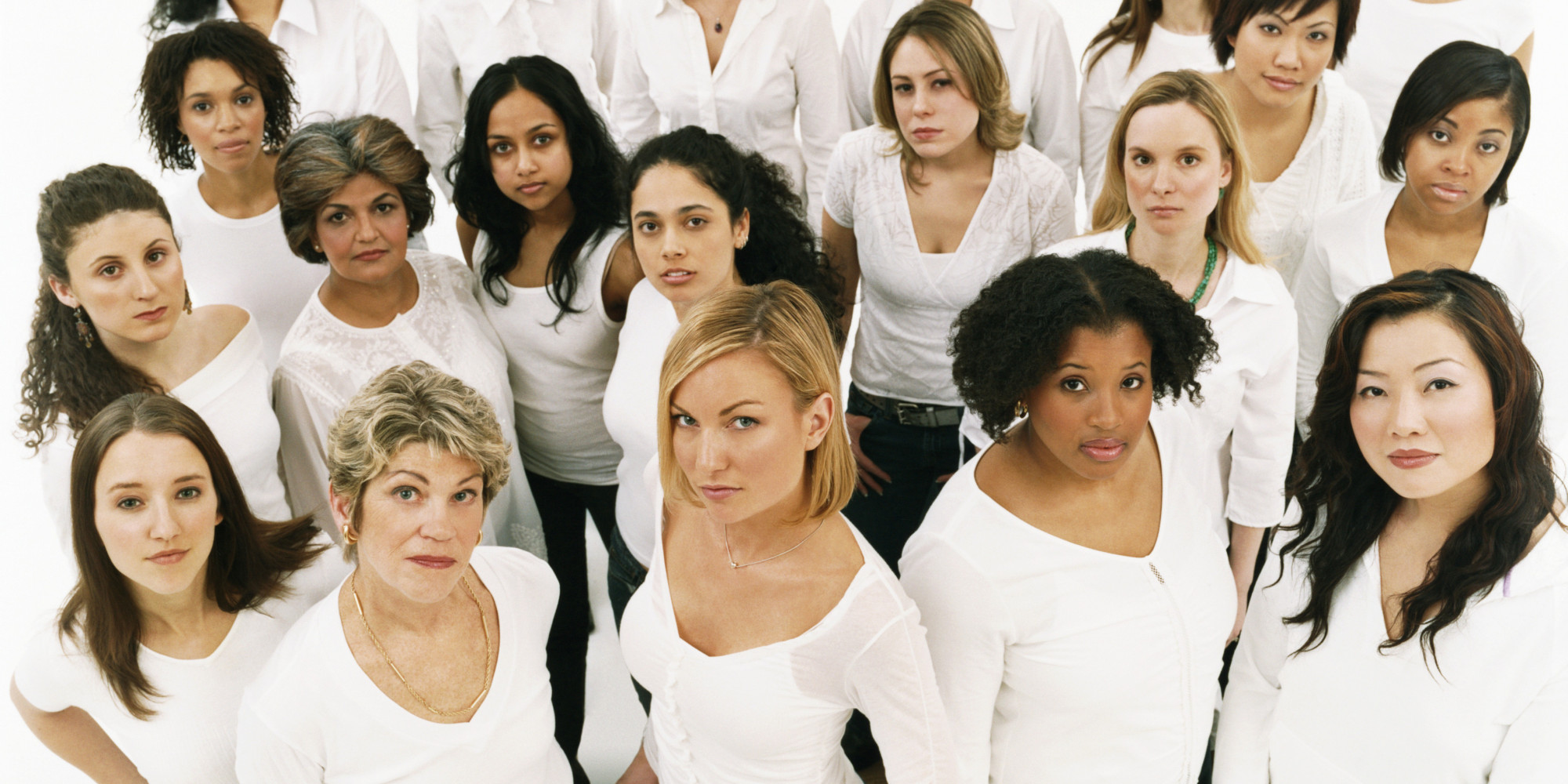 Studio Portrait of a Mixed Age, Multiethnic, Large Group of Displeased Women Wearing White Tops