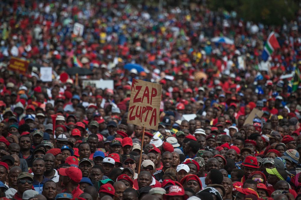 A protester holds a placard reading 'Zap Zupta', referring to Zuma and the Gupta Family, in Pretoria on April 12, 2017. Photographer: Mujahid Safodien/AFP/Getty Images
