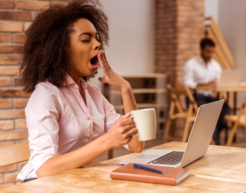 woman yawning while working
