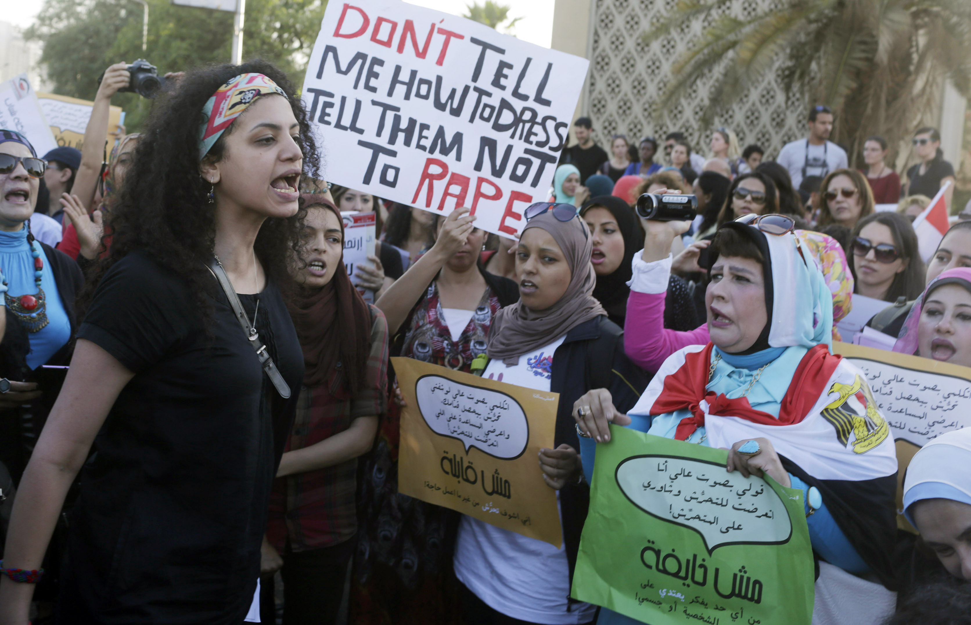 Women chant slogans as they gather to protest against sexual harassment in front of the opera house in Cairo June 14, 2014, after a woman was sexually assaulted by a mob during the June 8 celebrations marking the new president Abdel Fattah al-Sisi's inauguration in Tahrir square. Egypt has asked YouTube to remove a video showing the naked woman with injuries being dragged through the square after being sexually assaulted during the celebrations. Authorities have arrested seven men aged between 15 and 49 for sexually harassing women on the square after the posting of the video, which caused an uproar in local and international media. REUTERS/Asmaa Waguih (EGYPT - Tags: POLITICS CIVIL UNREST CRIME LAW) - RTR3TS3T