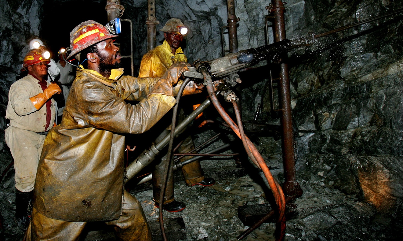 Mineworkers work deep underground at Harmony Gold Mine's Cooke shaft near Johannesburg, September 22, 2005.