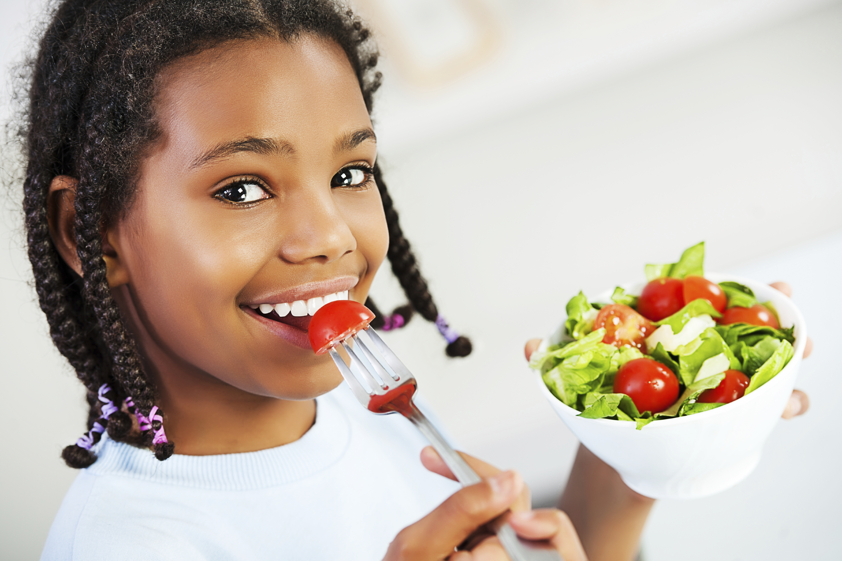 Little girl with healthy food. Eating salad and looking at camera.  [url=http://www.istockphoto.com/search/lightbox/9786682][img]http://dl.dropbox.com/u/40117171/children5.jpg[/img][/url]