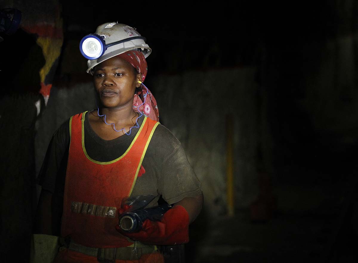 A female mine worker is seen underground  at Lonmin's Karee mine in Rustenburg, 100 km (62 miles) northwest of Johannesburg, March 5, 2013. Thousands of miners remained on strike at two shafts in South Africa's Marikana platinum mine on Tuesday, operator Lonmin Plc said, revising an earlier statement that they had gone back to work. REUTERS/Siphiwe Sibeko (SOUTH AFRICA - Tags: CIVIL UNREST BUSINESS EMPLOYMENT COMMODITIES) ORG XMIT: SSIB07