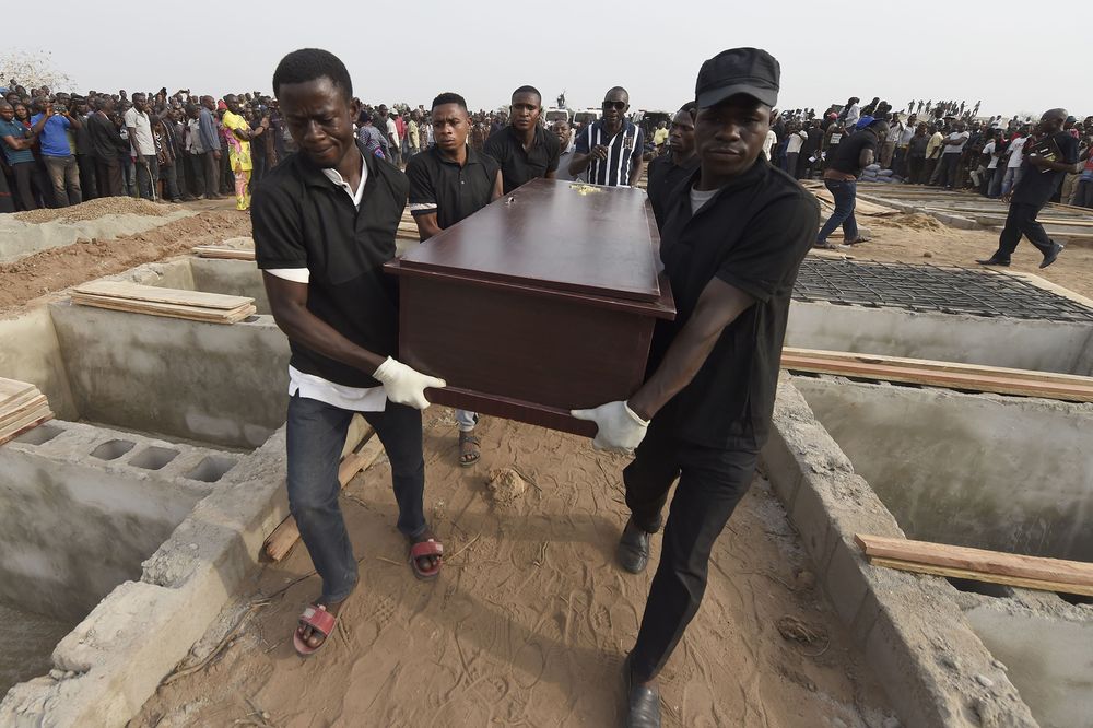 Pall bearers during the funeral service for people killed during cattle herder-farmer clashes in January 2018. Photographer: Pius Utomi Ekpei/AFP via Getty Images
