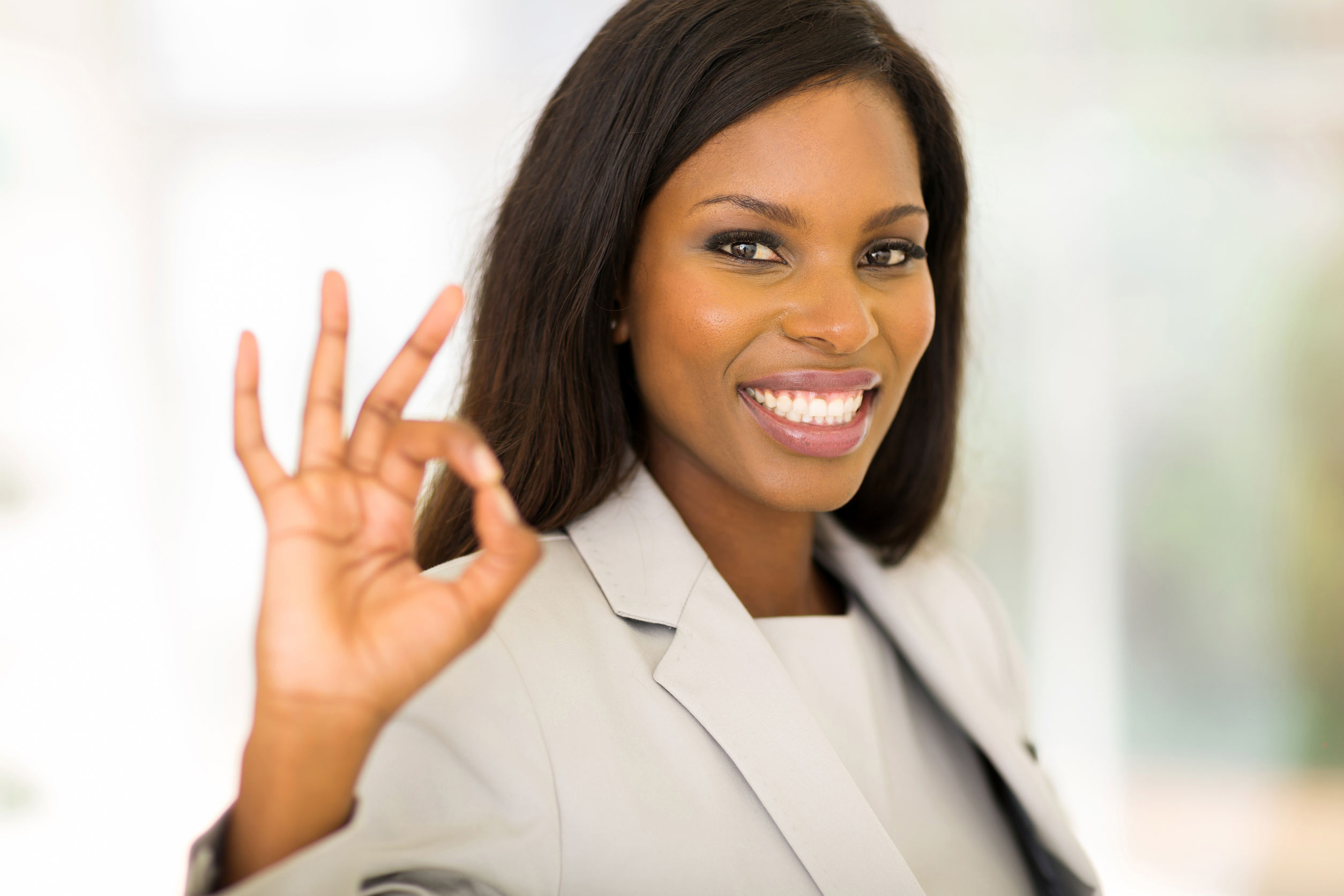38371545 - cheerful african american businesswoman giving ok hand sign