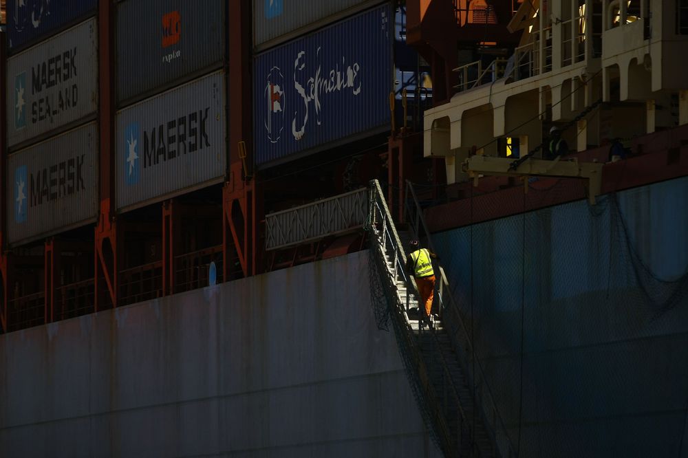 A dockworker climbs a gangway to board a container ship at the Port of Durban, operated by Transnet SOC Holdings Ltd.'s Ports Authority. Photographer: Kevin Sutherland/Bloomberg