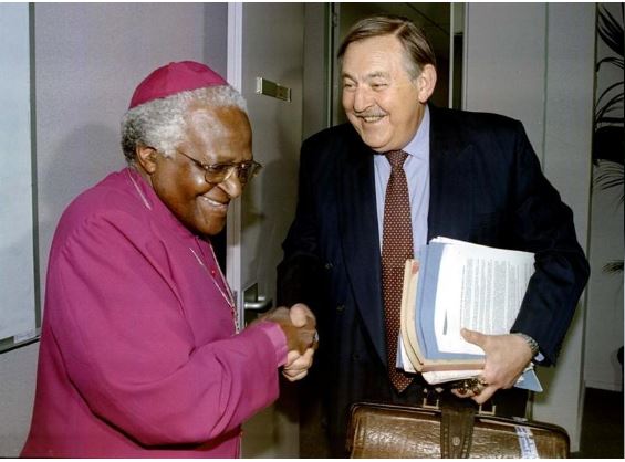 Former South African Foreign Minister Pik Botha shakes hands with Archbishop Desmond Tutu at the Truth and Reconciliation Commission (TRC) in Johannesburg, South Africa, October 14,1997. REUTERS/Juda Ngwenya/File Photo