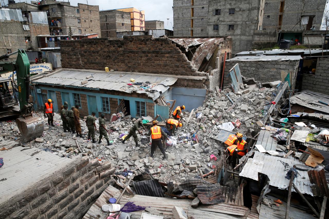Rescue workers search the rubble of a collapsed five-storey building where at least three people have been confirmed dead and several are feared trapped inside, in a residential area of Nairobi, Kenya, June 3, 2018. REUTERS/Baz Ratner