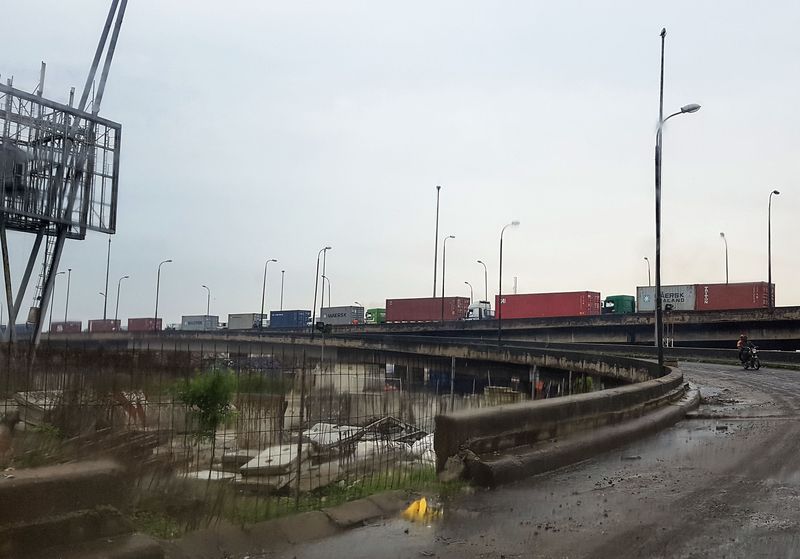 Container trucks sit stationary in heavy traffic on the approach to Apapa. Photographer: Paul Wallace/Bloomberg
