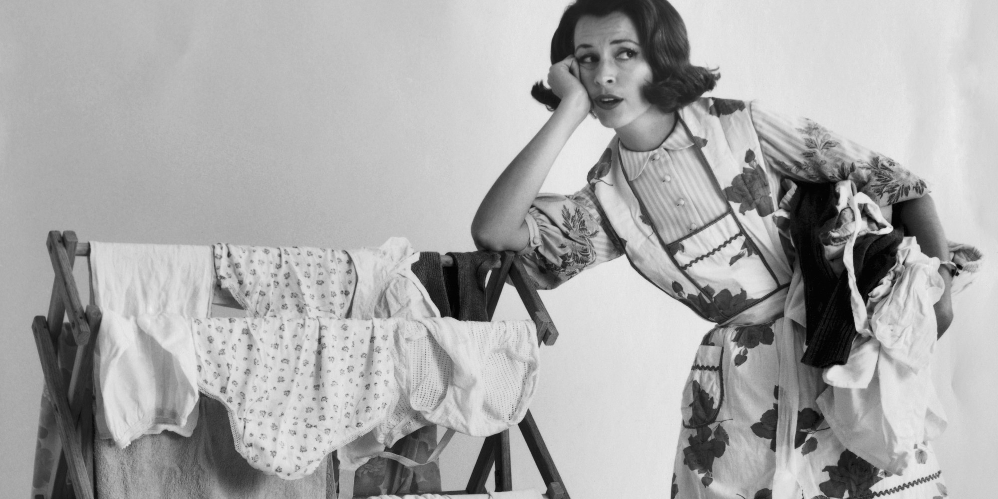 Young woman leaning on a drying rack