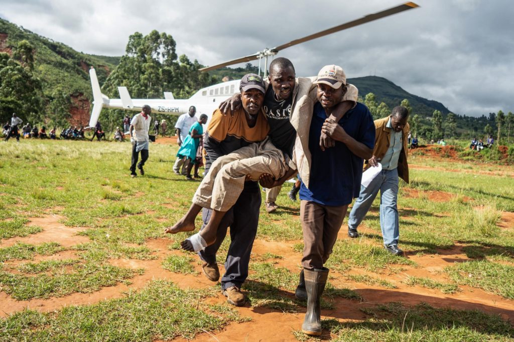 A wounded survivor is evacuated by helicopter from Chimanimani on March 19, 2019 to an hospital in Mutare, after the area was hit by the Cyclone Idai. - More than a thousand people are feared to have died in Mozambique alone while scores have been killed and more than 200 are missing in neighbouring Zimbabwe following the deadliest cyclone to hit southern Africa. Cyclone Idai tore into the centre of Mozambique on March 14 night before barreling on to neighbouring Zimbabwe, bringing flash floods and ferocious winds, and washing away roads and houses. (Photo by ZINYANGE AUNTONY / AFP) (Photo credit should read ZINYANGE AUNTONY/AFP/Getty Images)