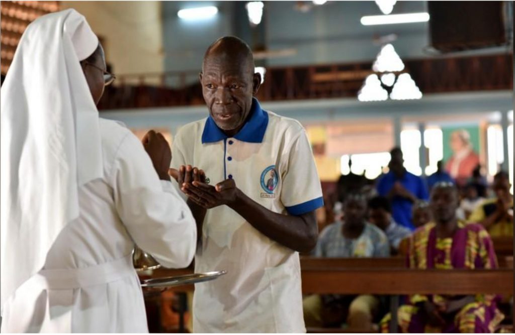 A catholic man receives communion at the cathedral of Our Lady of Kaya in the city of Kaya, Burkina Faso May 16, 2019. REUTERS/Anne Mimault
