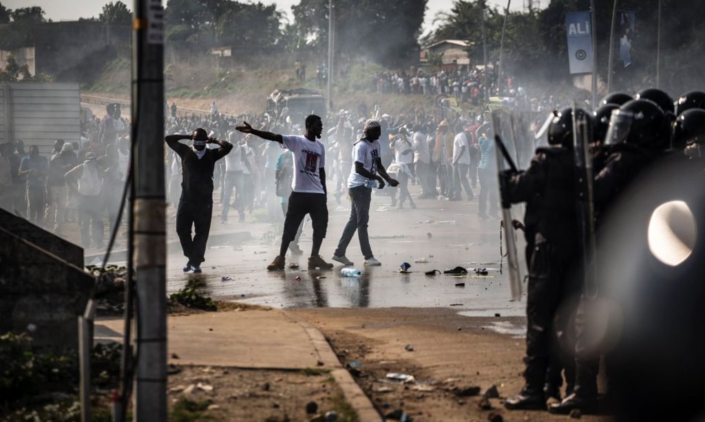 Supporters of Jean Ping demonstrate in front of security forces after incumbent Ali Bongo claimed election victory. Photograph: Marco Longari/AFP/Getty Images