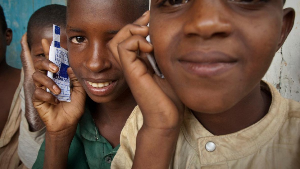 Children at a school in Gbiti, Cameroon, play with cellular phones that they drew, in this 2009 file photo. © UNHCR/ Frederic Noy
