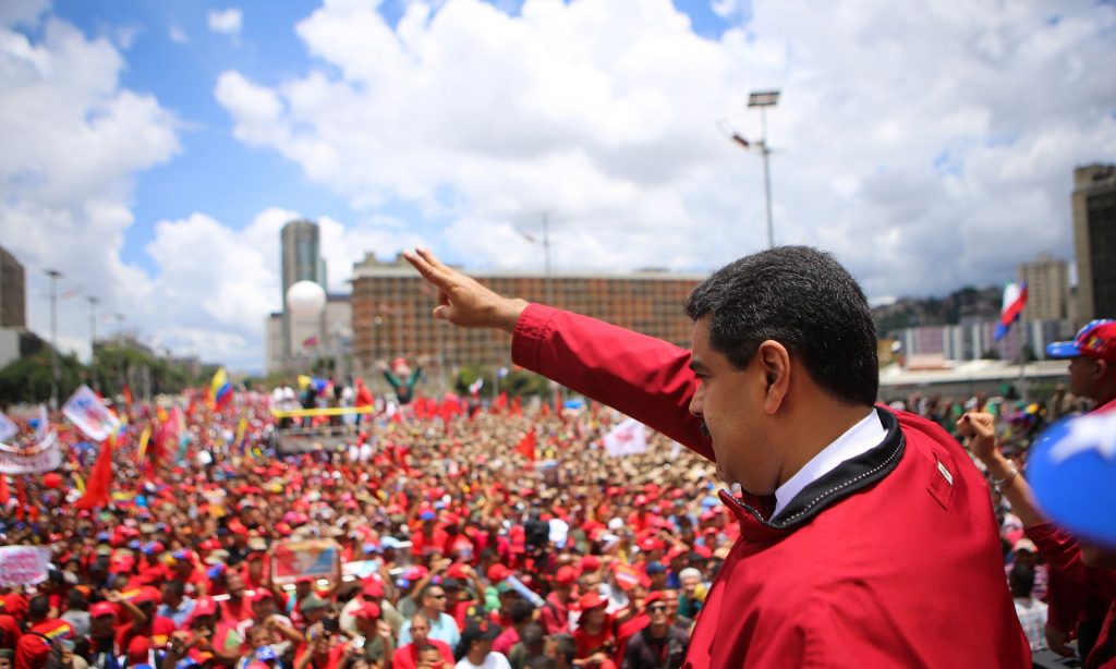 President Nicolás Maduro waves to supporters during a rally in Caracas on Thursday, in this image released by the presidential press office. Photograph: Marcelo Garcia/AFP/Getty Images