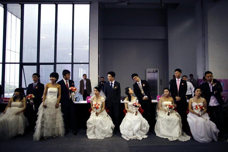 Couples wait to participate in a staged mass wedding, part of a matchmaking event to inspire singles to get married, Shanghai 2013. Carlos Barria/Reuters