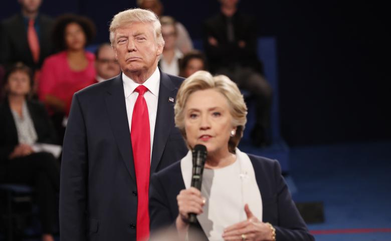 Donald Trump listens as Hillary Clinton answers a question from the audience during their presidential town hall debate at Washington University in St. Louis, Missouri. REUTERS/Rick Wilking