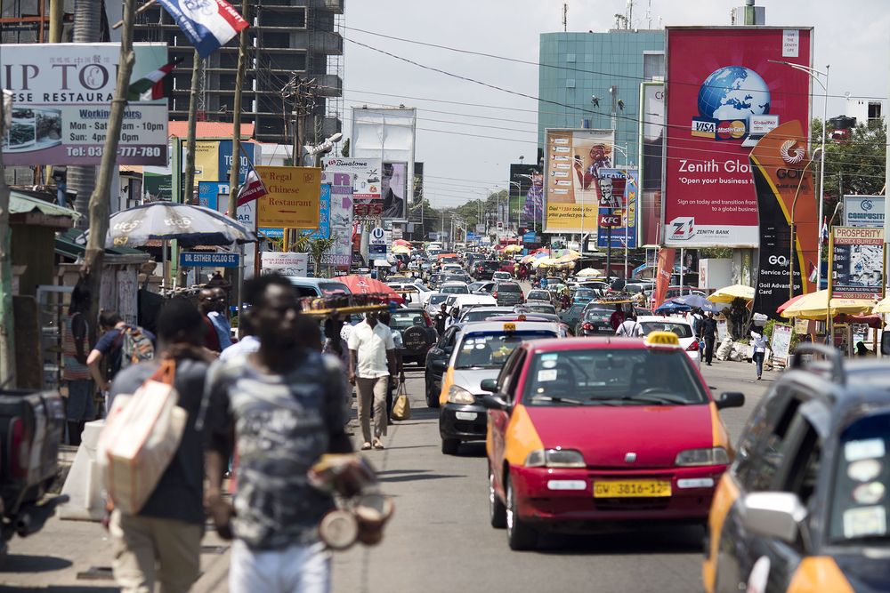 Road traffic passes business advertisements for Zenith Bank Plc and MTN Group Ltd. sit on a busy highway in Accra, Ghana. Photographer: Ty Wright/Bloomberg via Getty Images