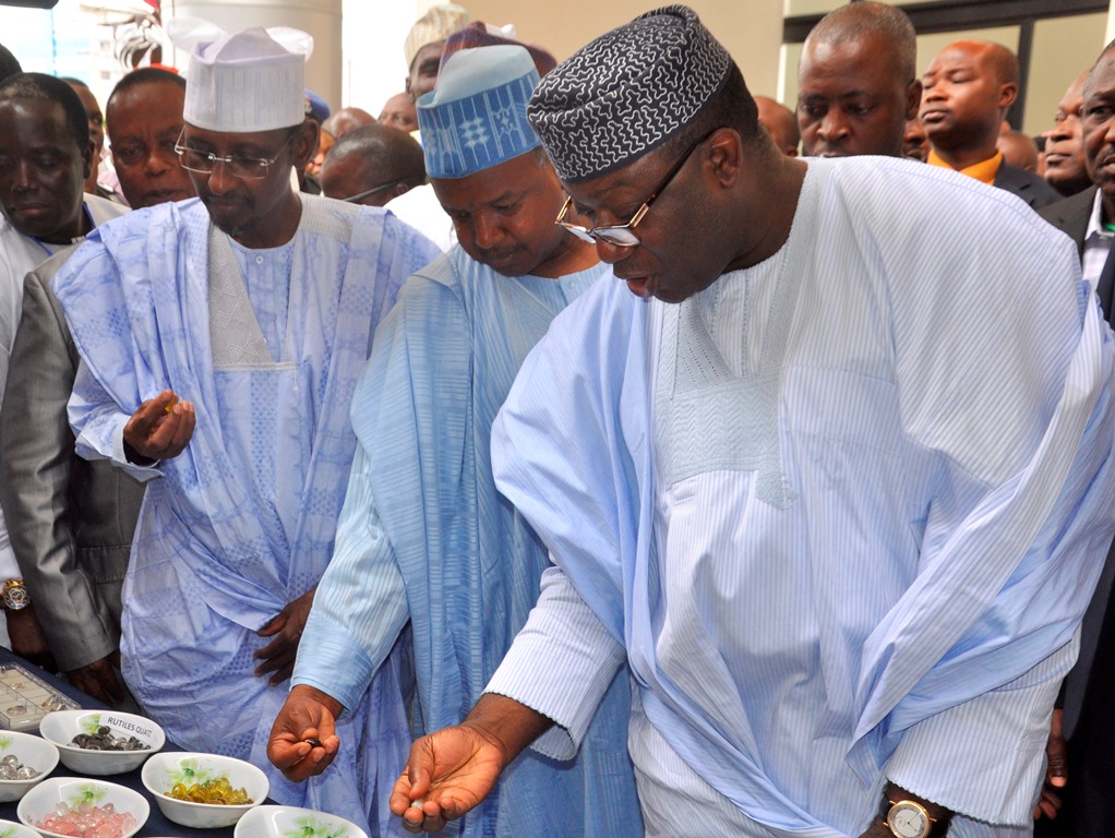 R-L: Minister of Mines and Steel Development, Dr Kayode Fayemi; Kebbi State Governor, Alhaji Abubakar Atiku Bagudu; and Minister of FCT/Guest of Honour, Mohammed Musa Bello; examining some precious stones at the closing session of the National Council on Mining and Mineral Resources Development (NCMMRD), in Abuja