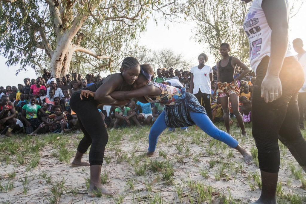 Girls and young women wait their turns to wrestle at the Festival of the King of Oussouye, where they can compete in traditional wrestling alongside the men. Ricci Shryock for BuzzFeed News