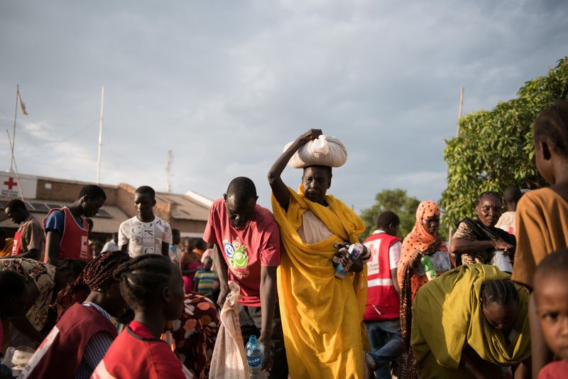 People wait at a Redcross compound in Wau, South Sudan. Photographer: Charles Lomodong/AFP via Getty Images