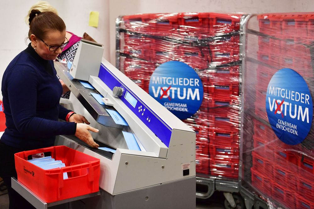 A volunteer operates an envelope opening machine prior to the counting of the ballots, at the headquarters of Germany's social democratic SPD party in Berlin on March 3. Photographer: John Macdougal/AFP via Getty Images