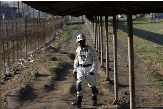 FILE PHOTO: A mine worker returns from the Lonmin mine at the end of his shift, outside Rustenburg, northwest of Johannesburg October 5, 2015. REUTERS/Siphiwe Sibeko