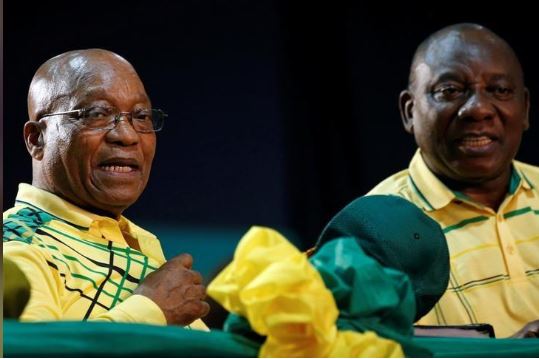 Former leader of South Africa Jacob Zuma sits next to President Cyril Ramaphosa at the 54th National Conference of the ruling African National Congress (ANC) at the Nasrec Expo Centre in Johannesburg, South Africa December 16, 2017. REUTERS/Siphiwe Sibeko/File Photo